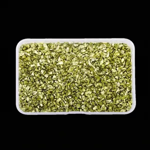 Macro view of metallic gold irregular crushed glass for nail art in a storage box