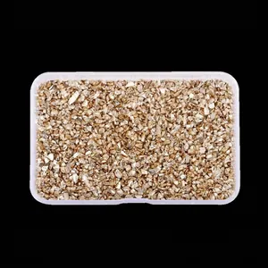 Detailed view of irregular golden high-bright glass crushed stones in a plastic box