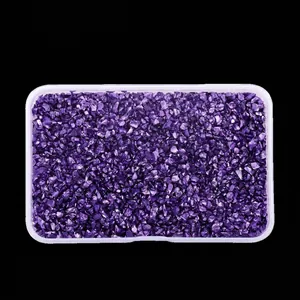 Detailed view of high-gloss purple crushed glass stones in a plastic box