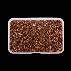 Top-down view of metallic brown crushed glass stones in a clear plastic container