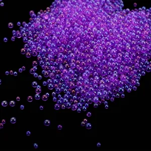Macro view of iridescent purple glass bubble beads for DIY nail art and craft decoration