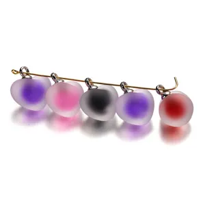 Macro view showing frosted acrylic heart pendants with vibrant inner bead-in-bead design