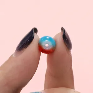Close-up of an 8mm blue and red gradient cracked glaze bead for DIY jewelry making.