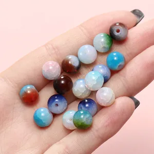 Detailed macro shot of 8mm multi-color ice-cracked glass beads with unique cloud patterns