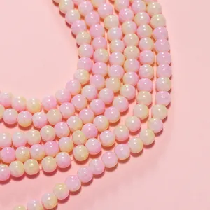 Detailed view of 8mm pink and yellow ice-crack glass beads for DIY jewelry and bracelet making