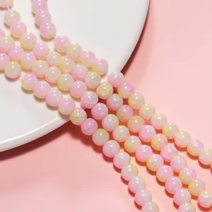 Close-up view of 8mm pink and yellow ice-crack glass beads for DIY handmade jewelry
