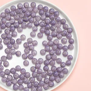 Detailed macro view of 10mm purple crackle glass beads for DIY jewelry making crafts