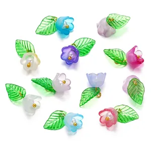 Detailed view of colorful acrylic flower and leaf pendants with pearls for DIY projects