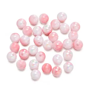 Dettaglio macro di perle tonde in acrilico con sfumatura rosa cangiante per gioielli fai da te