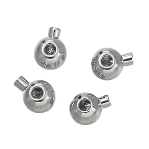 Macro view of four silver-tone metallic cord ends for DIY pearl necklace jewelry making