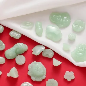 Detailed macro view of assorted green glass imitation jade pendants for DIY jewelry