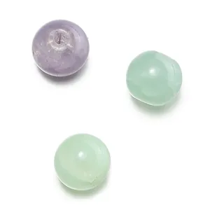 Close-up macro detail of 10mm purple and mint green crackle opal glass beads for DIY jewelry
