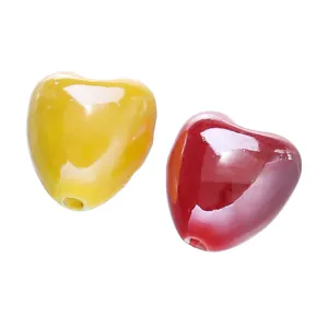 Close-up of glossy heart-shaped candy color ceramic beads for DIY jewelry making.