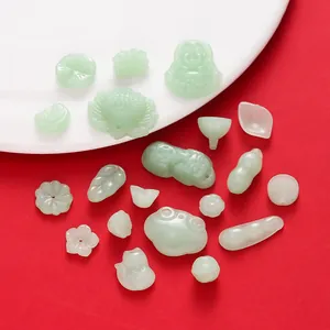 Close-up of assorted light green glass imitation jade pendants for DIY jewelry making