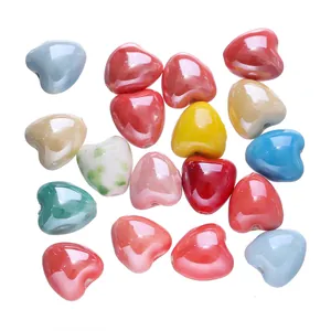 Macro detail of glossy candy-colored heart-shaped ceramic beads for DIY jewelry