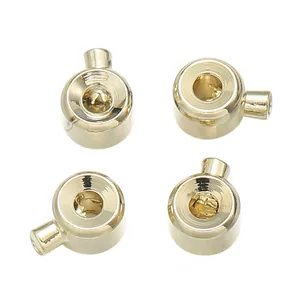 Detailed close-up of four 18K gold-plated jewelry end caps for DIY bracelets