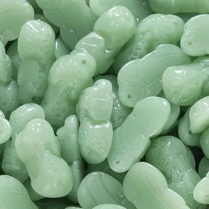Detailed view of green glazed imitation jade Pi Xiu charms for DIY jewelry making.
