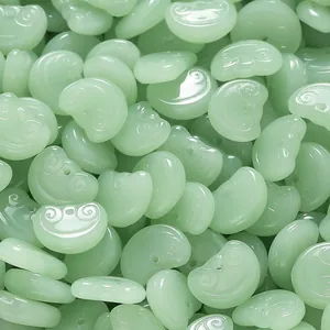 Detail view of light green Ruyi-shaped glass beads for DIY jewelry making and crafts