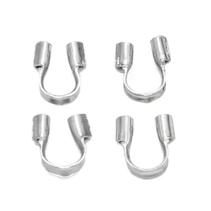 Detailed view of four silver U-shaped wire protectors for DIY necklace and bracelet crafting
