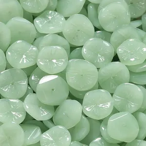 Macro detail of pale green translucent jade-style glass beads for jewelry DIY craft