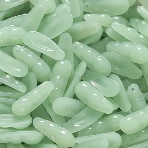 Macro view of light green glass imitation jade pendants for bulk DIY jewelry making