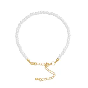 Detailed macro view showing the 18K gold-plated clasp and extender on a white pearl bracelet