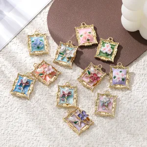 Detailed view of assorted vintage alloy frame floral charms with pearls for DIY jewelry making
