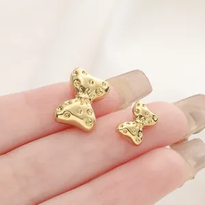 Primo piano di perle distanziatrici a clessidra placcate oro 18K per gioielli fai da te