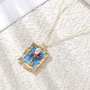 Macro detail of a vintage style gold alloy photo frame flower pendant with pearl
