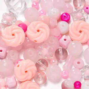 Dettaglio macro di perle rosa mix fai da te con forme a spirale e floreali.