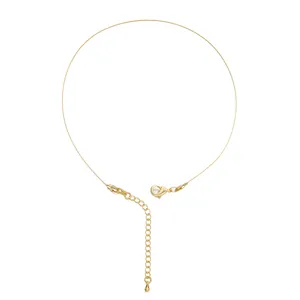 Close-up of 18K gold-plated lobster clasp and extender chain on fine steel wire
