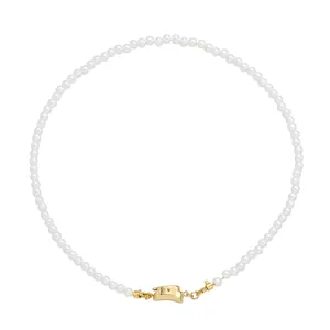 Detailed close-up of 18K gold-plated clasp on elegant handmade white pearl necklace