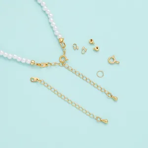 Close-up macro view of 18K gold-plated jewelry findings with white pearl beads