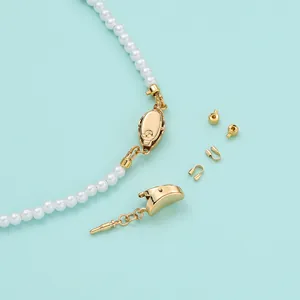 Detail shot of 18K gold-plated DIY jewelry clasp kit with white pearls on blue background.