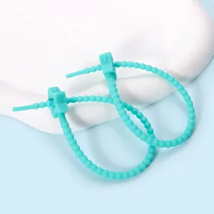 Teal star-shaped silicone cable tie organizer for doll charms and cable management