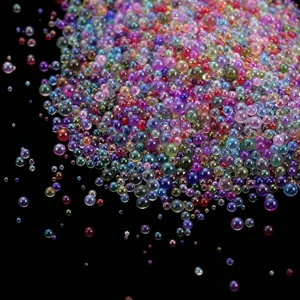 Macro detail of iridescent multi-colored no-hole glass bubble beads for DIY craft