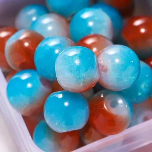 Macro detail of 8mm cracked glass beads in blue and orange for DIY jewelry making.