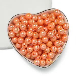 Orange iridescent AB acrylic round beads for DIY jewelry making in a heart bowl