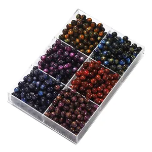 Close-up view of colorful resin cat-eye beads in a clear 6-compartment jewelry box