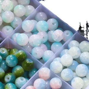 Macro shot of 8mm ice-crack glass beads for DIY jewelry making in a storage box.