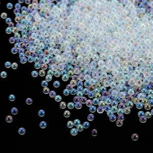 Macro view of iridescent transparent glass bubble beads for DIY nail art and crafts.