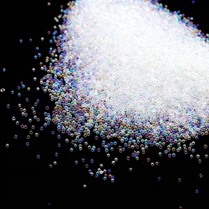 Macro detail of tiny transparent iridescent glass bubble beads for nail art decoration