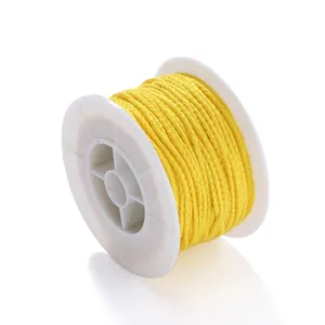Detail view of a roll of bright yellow non-elastic braided cord for DIY jewelry making.
