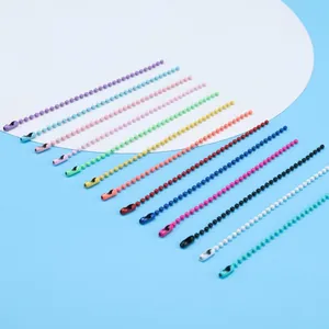 Detailed view of colorful painted metal ball chains with connectors for DIY crafts.