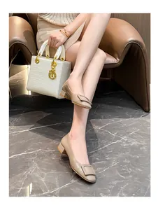 Elegant beige patent leather square toe pumps with buckle detail and comfortable low block heel.