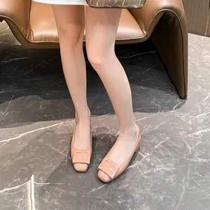 Elegant beige patent leather square-toe pumps with a buckle and a low chunky heel.