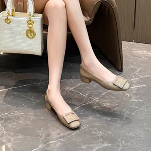 Elegant patent leather square toe pumps featuring a decorative buckle and low block heel