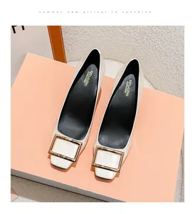 Top view of elegant cream square toe pumps with a glossy finish and gold buckle
