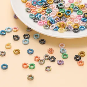 Macro view of colorful metallic thread ring spacers for DIY handmade braided jewelry