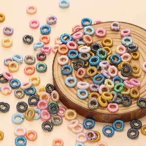 Macro view of assorted colorful iridescent metallic thread coils for DIY handmade jewelry crafts